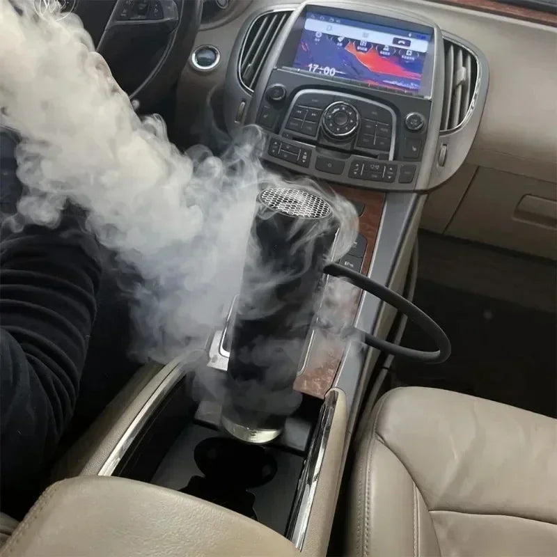 Car interior with a gloved hand using a handheld portable hookah emitting steam.