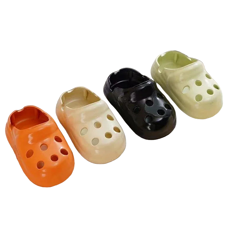 Four ceramic croc-shaped ashtrays in different colors