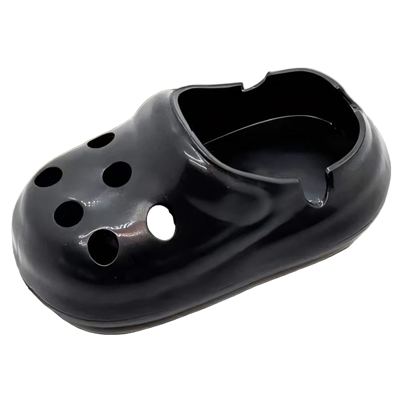 Black rubber ashtray shaped like a croc shoe with multiple holes.