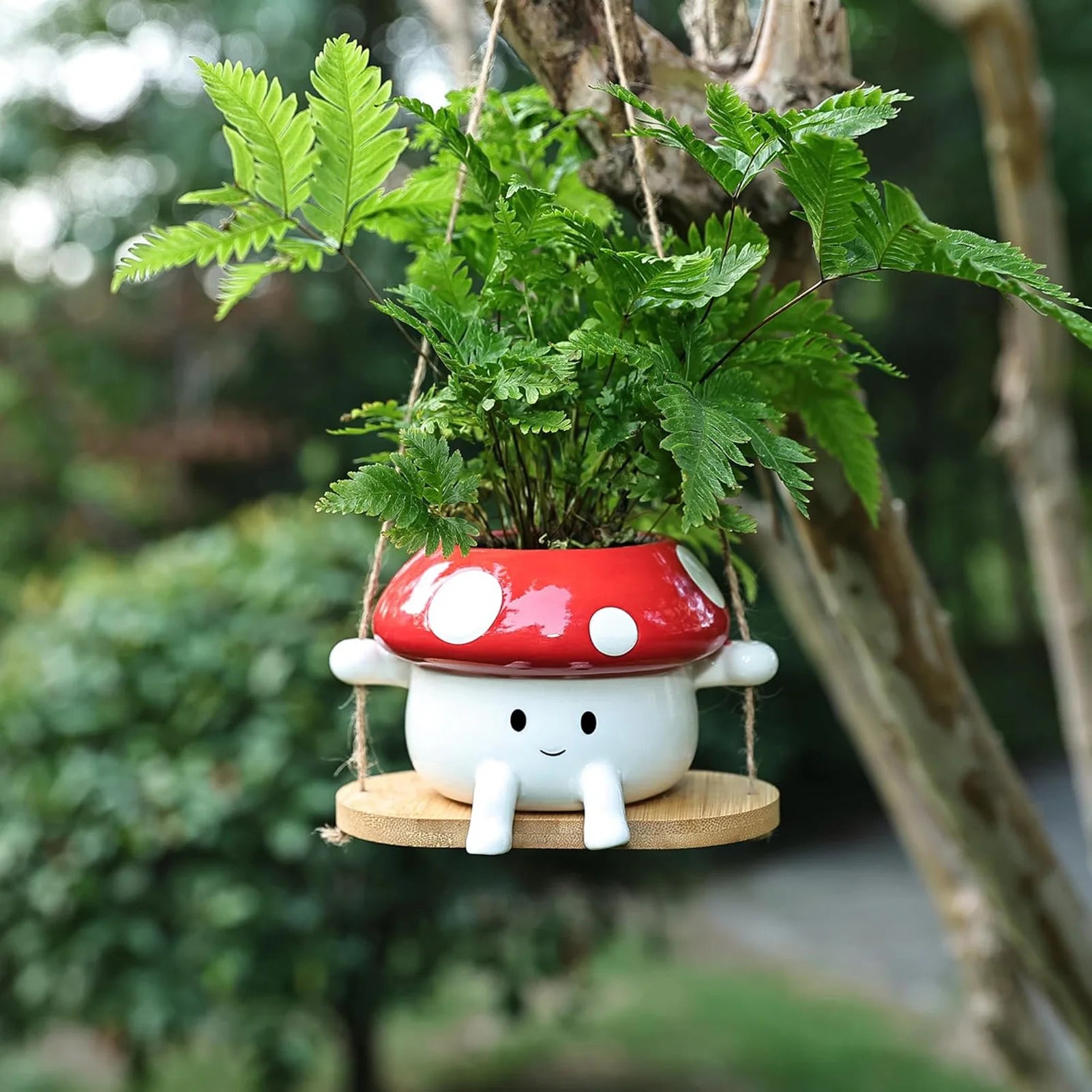 Mushroom-shaped plant pot with a green plant on a blurred natural background