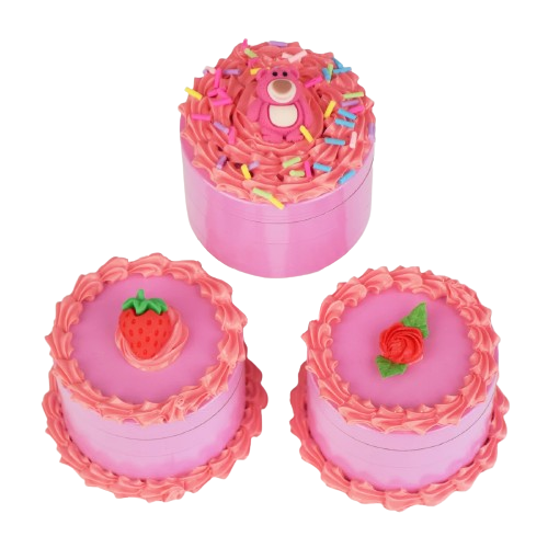 Three pink cake-shaped grinders with decorative elements