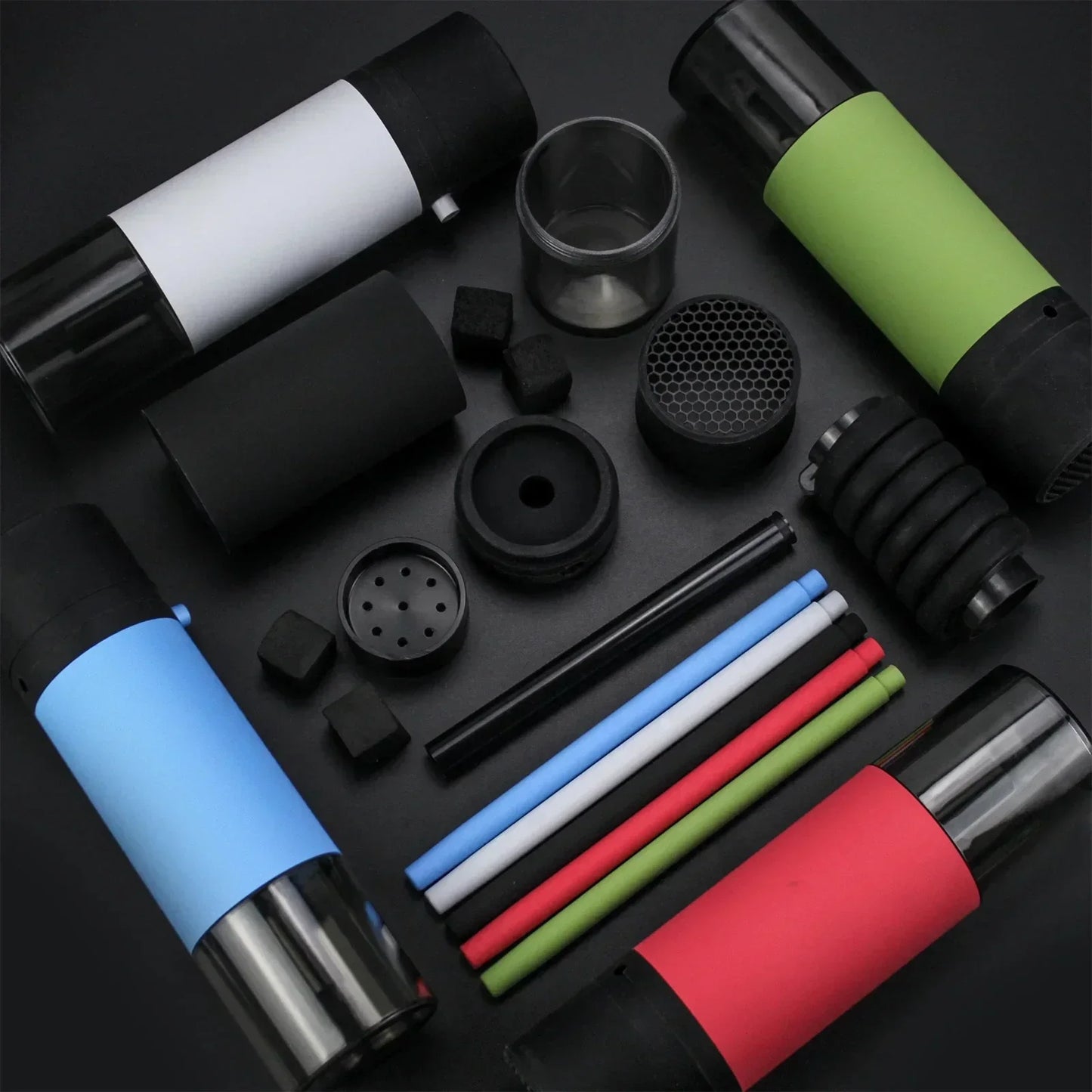 Collection of various portable hookah accessories on a dark surface